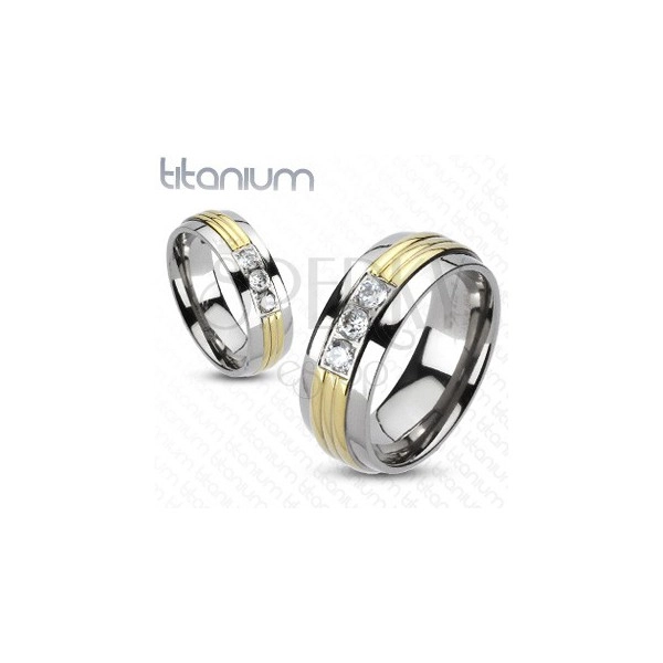 Prsten od titana - sredina zlatne boje, tri prozirna cirkona